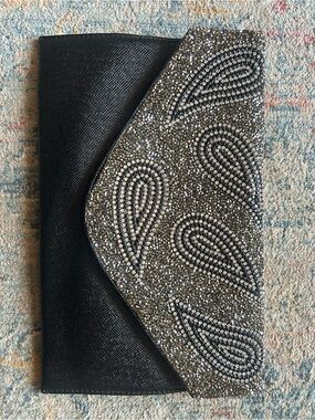 Natasha Couture Black Satin Wristlet with Metal Logo